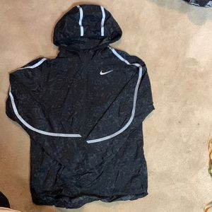 Nike lightweight reflective windbreaker. Black. Drawstring bottom and hood.